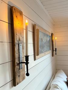 a room with two candles on the wall at Unique 200-year old tiny house in Old town in Stavanger