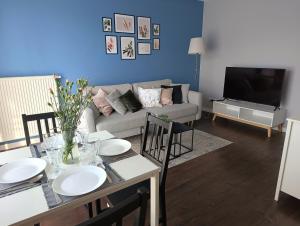 a living room with a table and a couch at Apartament Siedlce 2 in Siedlce