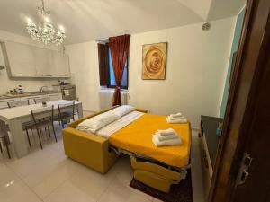 a bedroom with a bed with towels on it at Anime Sante Apartment - Piazza Duomo in LʼAquila