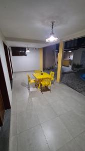 a yellow table and chairs in a room at Pousada Dunas do Sol in Natal