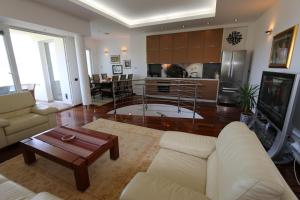 a living room with a couch and a table and a kitchen at Villa Tripalo in Šilo