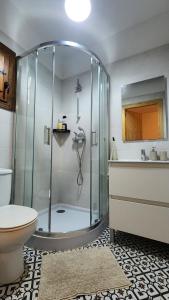 a bathroom with a shower with a toilet and a sink at Bakit House - Casa rural con piscina in Águilas