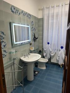 a bathroom with a sink and a toilet and a shower at Residenza Brancondi in Loreto