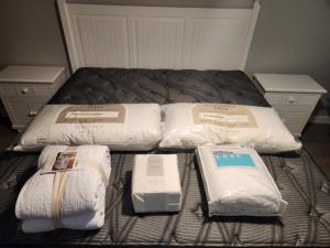 a bed with three pillows and towels on it at SPI FUN! - Beach View - 2025 Full Remodel - 2BR Condo OV502 in South Padre Island +8 photos