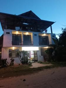 a house with lights on the front of it at Chimicuas House in Puerto Maldonado