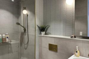 a bathroom with a shower and a sink at Sky One Harmony in Box Hill +23 photos