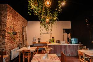 a restaurant with tables and chairs in a room at Casa Josefina Hotel Boutique in Olavarría +31 photos