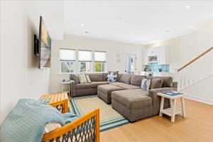 a living room with a couch and a table at Spacious Newly Built Townhouse 2 blocks to Beach in Ventnor City