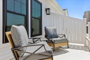 two chairs and a table on a balcony at Spacious Newly Built Townhouse 2 blocks to Beach in Ventnor City