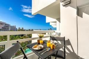 a table with a plate of food on a balcony at GOLDEN VIEW Ponderosa in Costa de Adeje