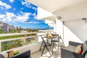 a balcony with a table and chairs and a view of the city at GOLDEN VIEW Ponderosa in Costa de Adeje