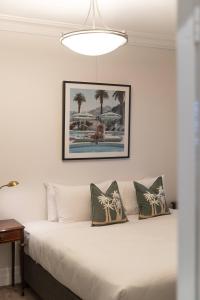 a bedroom with a white bed with pillows at The Bay Retreat - Neutral Bay in Sydney