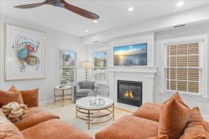 Luxurious OC Single Family Home with Hot Tub في أوشن سيتي: غرفة معيشة مع أريكة ومدفأة