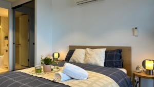 a bedroom with a blue bed with a tray on it at Sky One Harmony in Box Hill