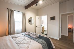 a bedroom with a bed with two towels on it at City Oasis - Entire Designer House - Near Disneyland in Hacienda Heights