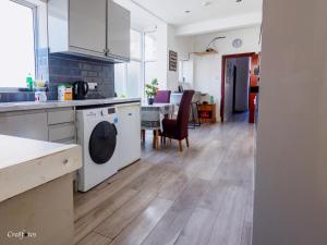 a kitchen with a sink and a dishwasher at Wood Hus Lodge Very Lovely Specious Room 5 in Stoke on Trent