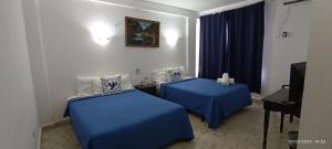 Cama ou camas em um quarto em Hotel Coral