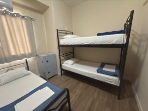 a room with three bunk beds and a window at Paloma in Athens