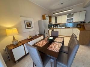 a kitchen and dining room with a table and chairs at My Home in Alexandroupoli