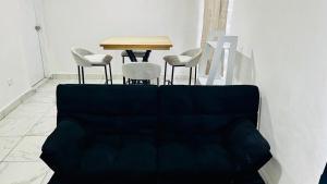 a living room with a couch and a table and chairs at Relax Depa in Matamoros
