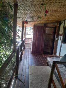a porch of a house with a wooden floor at Chalé Bambu3 in Cunha