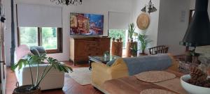 a living room with a couch and a table at Macondo entre cerros y mar - con seña in Piriápolis