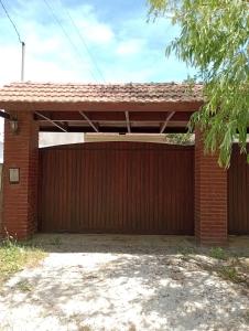 a red brick garage with a large door at Depto TOMY in Mar de Ajó