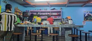 a group of people standing around a counter in a kitchen at Gringo Petes Too in Fortuna