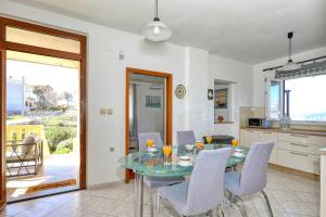a kitchen and dining room with a glass table and chairs at Mediterranean Charm By Milena in Novigrad Dalmatia