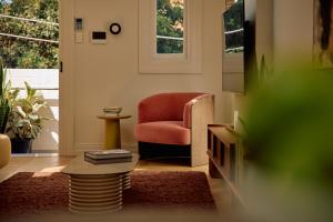 a living room with a chair and a television at Flora Suite in Sydney