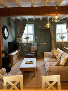 a living room with a couch and a coffee table at Copley Cottage in Copley