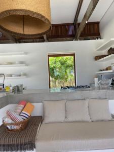 a living room with a couch in a kitchen at Casa Terra in São Miguel do Gostoso