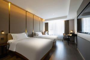 Postel nebo postele na pokoji v ubytování National Jade Hotel + 37 fotografií