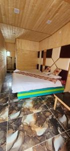 a bedroom with a bed with a painting on the floor at Hotel Big Dreams in Kolur