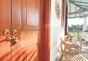a wooden door in a room with a table at Marshmellow Surf Camp Sri Lanka in Ahangama +32 photos