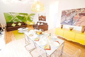 a dining room with a table and chairs in a living room at Wenceslas Square Lofts in Prague