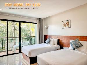 two beds in a hotel room with a balcony at XAYA Pool Access Resort - Phuket in Phuket +11 photos