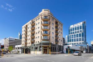 a tall white building on a city street with a car at Walk & Wander - A Sepal Stay in Perth