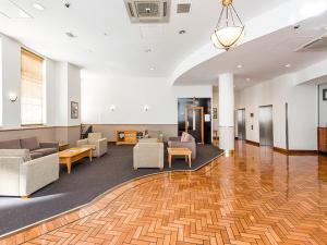 a lobby with couches and chairs in a building at Walk & Wander - A Sepal Stay in Perth