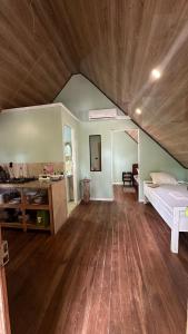 a large room with a bed and a wooden floor at Cabaña Vacal Wifi, beach front #2 in Uvita