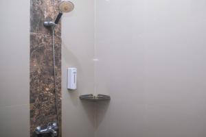 a shower in a bathroom with a shower at Joglo Manggisan Syariah Kotagede Mitra RedDoorz in Yogyakarta +55 photos