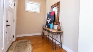 a hallway with a console table and a mirror at Luxury Pet-Friendly Kanab Home Quiet Neighborhood in Kanab