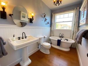 a bathroom with a sink and a toilet and a mirror at Luxury Pet-Friendly Kanab Home Quiet Neighborhood in Kanab