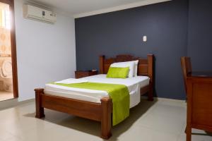 Rúm í herbergi á Hotel el imperio