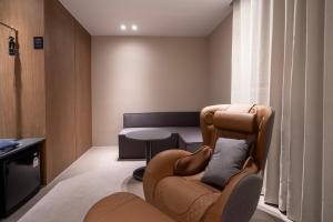 a living room with a chair and a table at Justsleep hotel Gunsan Naun in Gunsan
