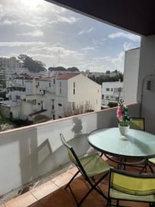 a table and chairs on a balcony with a view at OuraSea Apartment in Albufeira