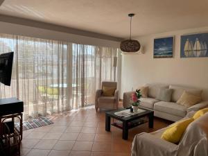 a living room with a couch and a table at OuraSea Apartment in Albufeira