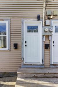 a house with a white door and two windows at Queens Suite 1bdrm in St. John's