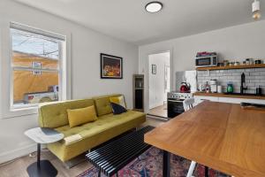 a living room with a green couch and a table at Queens Suite 1BR Free Parking in St. John's