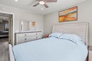 a bedroom with a bed and a ceiling fan at Jersey Shore Getaway in Seaside Heights +37 photos